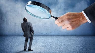 person under magnifying glass fbde