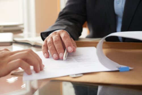 business people signing contract scaled